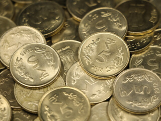 closeup shot of a collection of vintage golden 5 or five rupees in a pile of authentic indian coins