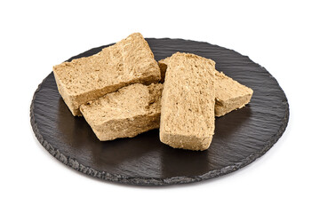 Pieces of sunflower halva, isolated on white background.