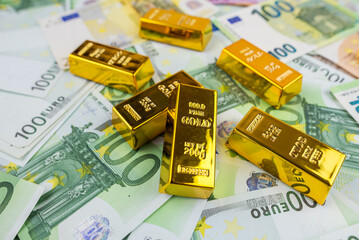 Euro banknotes and gold bars.