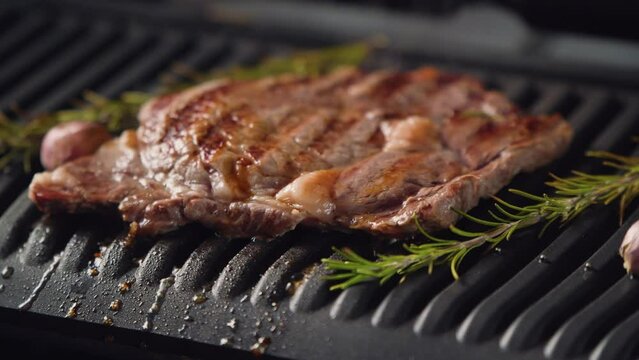 Hot delicious beefsteak on electic grill. 4k video footage