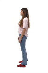 side view of a young girl standing on white background