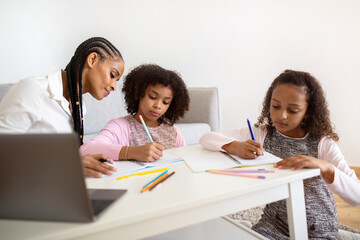 Black Schoolgirls At Laptop Having Lessons With Tutor At Home