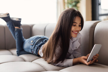 Happy Girl Using Smartphone Texting Scrolling Social Media At Home