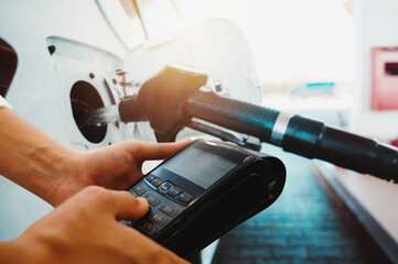 Bank pos ready to pay for a car fuel refueling