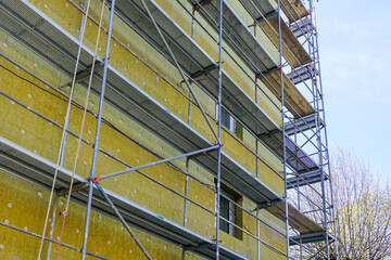 Thermal insulation of the facade of a apartment building with thick rock mineral wool plates