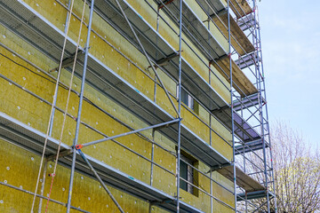 Thermal insulation of the facade of a apartment building with thick rock mineral wool plates