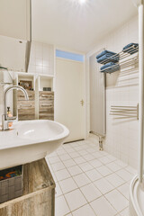 a modern bathroom with white tiles and wood panels on the walls, along with a large mirror in the corner