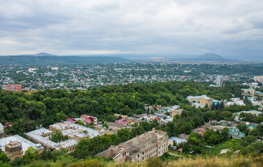Fototapeta na wymiar Pyatigorsk, Stavropol Territory, Russia - July, 21, 2022: panoramic view of the historical part of the city with beautiful architecture from the observation deck on a cloudy summer day