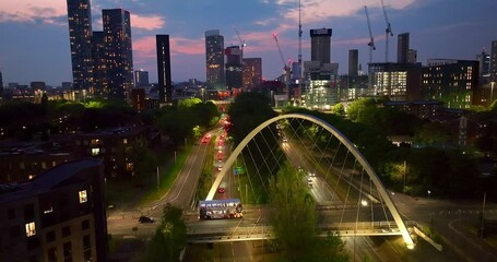 Manchester skyline aerial view during twilight filmed from Princes road and showing the new skyscrapers at Deansgate square and the traffic at the Mancunian way.