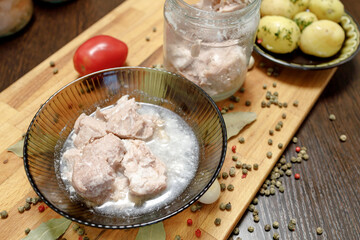 stewed meat in a glass plate, fat on the surface