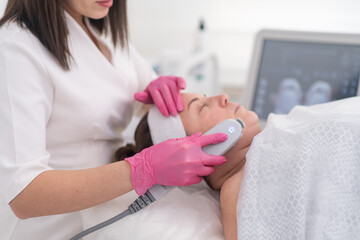 beauty center provides a relaxing environment for a female client to receive a SMAS ultrasound face...