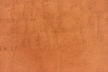 Rough textured surface of a terracotta wall. Background or backdrop. Blank for design, graphic...