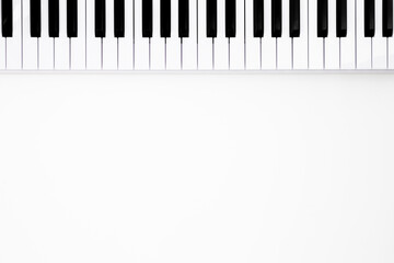 Fototapeta premium Musical keyboard on a white background, flat lay, space for text. Minimalistic music background, conceptual minimalism.