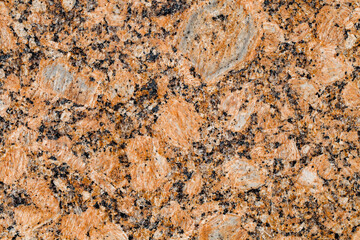 Marble tile orange with inclusions, close-up, uniform texture background