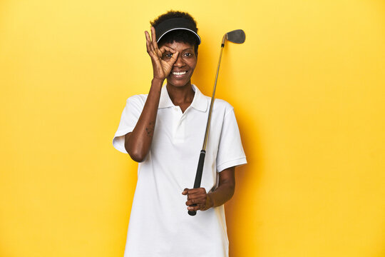 African golfer woman with her golf club, sports concept, excited keeping ok gesture on eye.