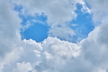 Naklejka na ściany i meble Cumulus clouds against a light blue sky with a clear fiber structure.