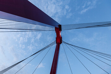 shot was taken from underneath a red bridge and blue sky