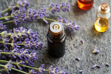 A dropper bottle of essential oil with lavender flowers