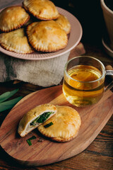 Oven Baked Pastries Filled with Chives and Mushrooms with Cup of Green Tea