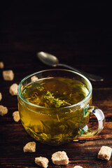 Cup of herbal tea with refined sugar