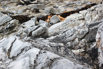 Texture of gray stone, large and small stones on the seashore, rocks, mountains