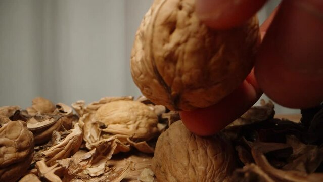 You attempt to crack open the walnut with one hand, but you're unable to do so. Dolly slider extreme close-up.