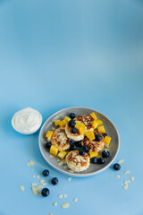 Breakfast with cheesecakes and berries on blue background