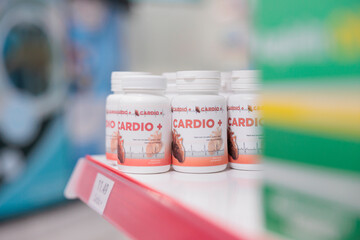 Pharmacy shelves fiiled with cardiology pills ready for customers to come and buy during checkup visit. Drugstore also carried a variety of other medical products, such as bandages and cold medicine.