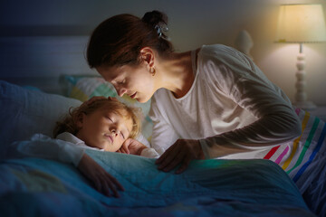 Obraz na płótnie Canvas Child sleeping in dark bedroom. Little boy napping