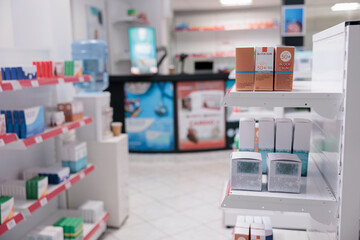 Empty drugstore with nobody in it equipped with shelves full of pills packages and pharmaceutical products ready for clients. Pharmacy filled with supplements, health care support service and concept
