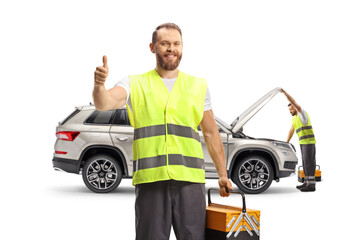 Roadside assistance compay workers checking a SUV and gesturing thumbs up