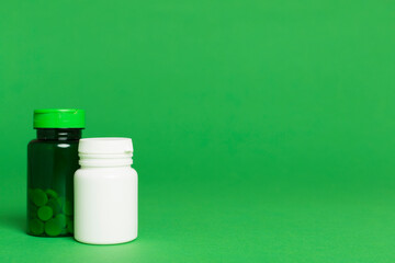 Plastic bottles for vitamins on color background