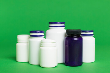 Plastic bottles for vitamins on color background