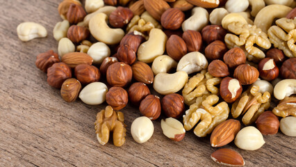 mix of nuts on a wooden table - generative ai