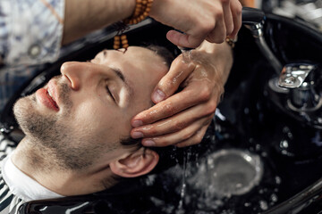 Washing a head before haircut in barbershop