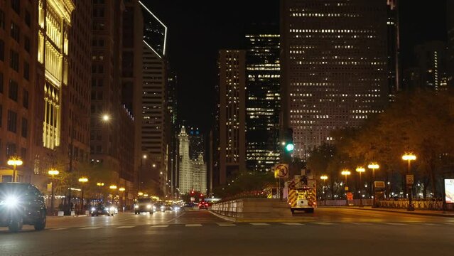 Chicago, USA - April 30, 2023: night cityscape of chicago downtown city with road and skyscraper, slow motion
