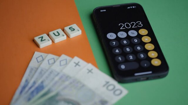 money and calculator on the table, calculations, the inscription "ZUS", 2023