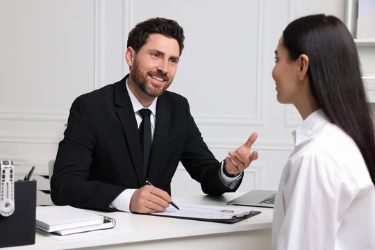 Human resources manager conducting job interview with applicant in office