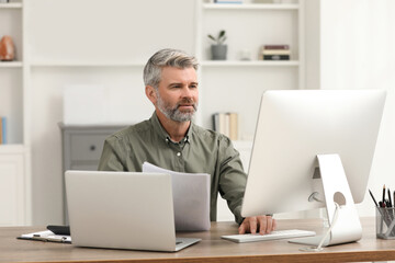 Professional accountant working at wooden desk in office