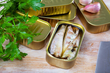 Image of salty fillet of mackerel in sunflower oil in open tin can