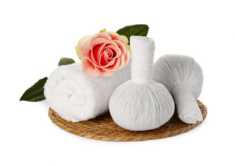 Beautiful spa composition with rolled towel, flower and herbal bags on white background