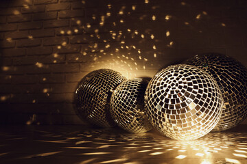 Many shiny disco balls near brick wall indoors, color toned. Space for text