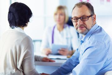 Fototapeta premium American doctor talking to woman in surgery