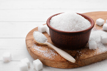 Different types of sugar on white wooden table, space for text