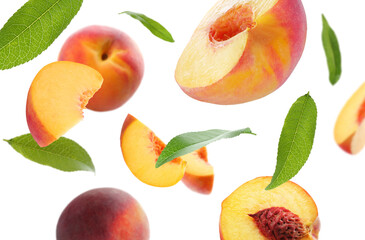 Juicy fresh peaches with green leaves falling on white background