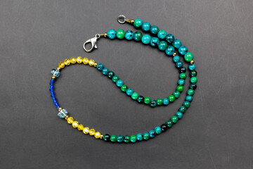 Colorful gemstone crystal beads necklace on black, unique handmade jewelry background, promotional photo for an online jewelry store