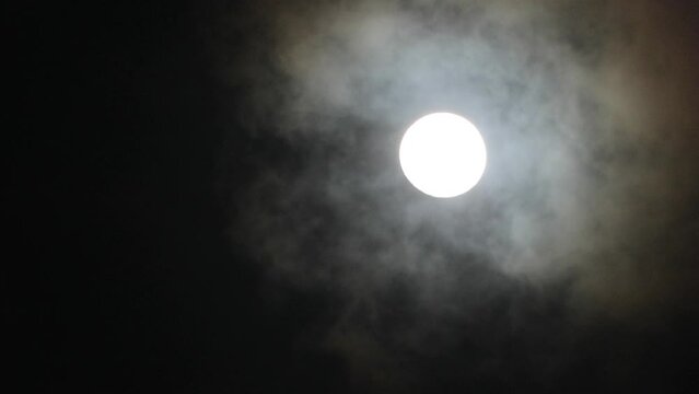 Super full moon with dark clouds