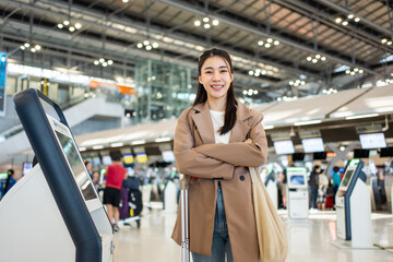 Portrait of Asian young girl walk in airport terminal to boarding gate. 