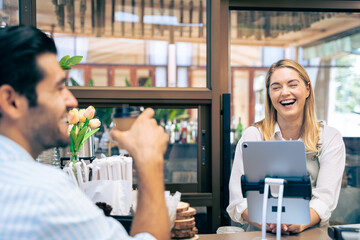 Caucasian attractive man receive hot coffee from waiter in coffee house. 