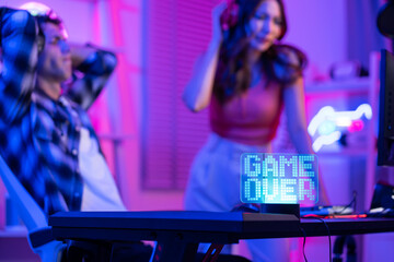 Close up of e-sport couple loser gamer play online video game on computer.  